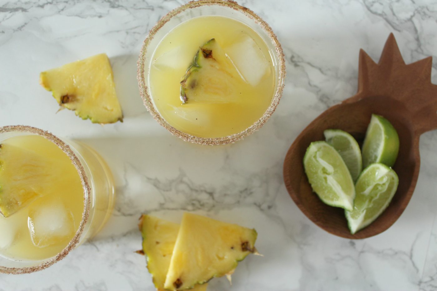 Be sure to garnish your pineapple cinnamon margarita with fresh pineapples. Not only is it beautiful but the pineapple is delicious to eat after you've finished your drink.