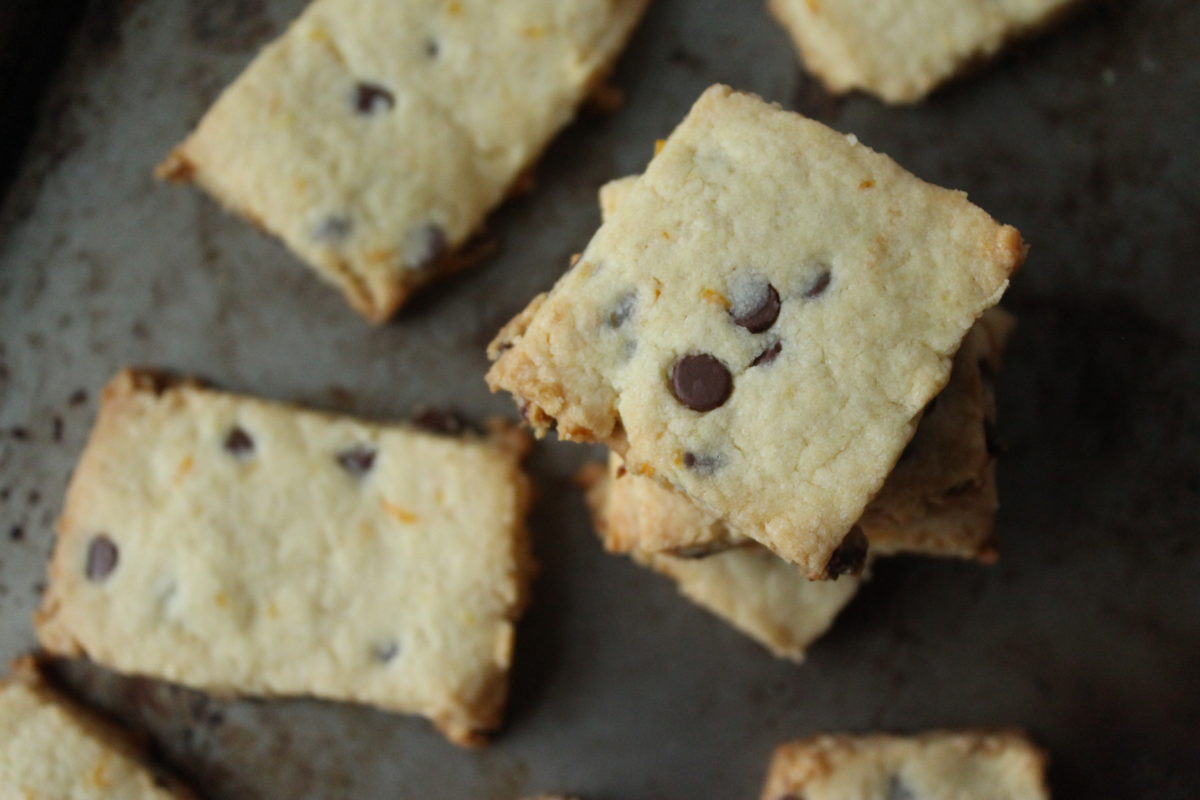 Stacked shortbread cookies on baking sheet.