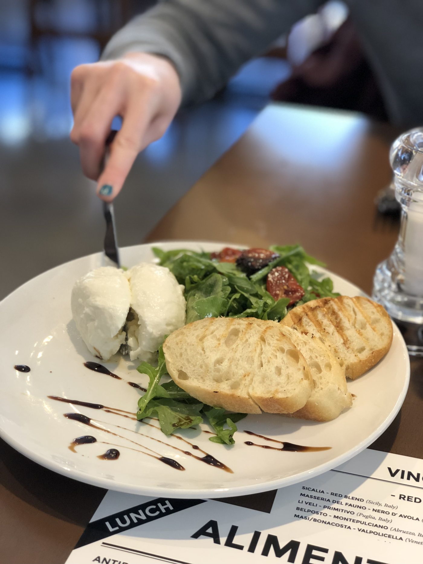 knife cutting into fresh burrata