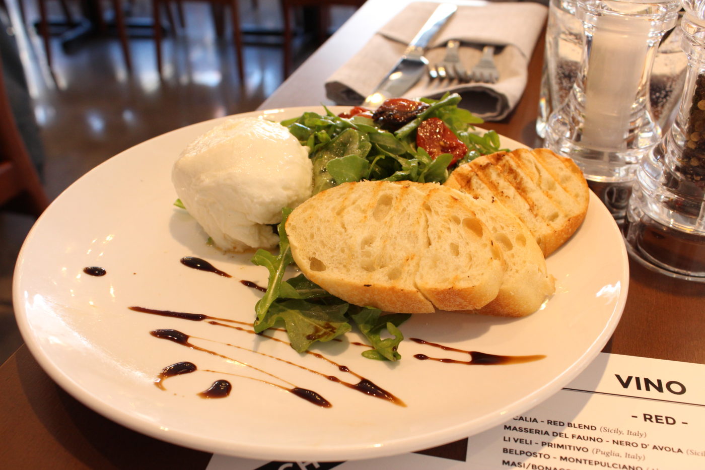 appetizer plate of bread, arugula and burrata