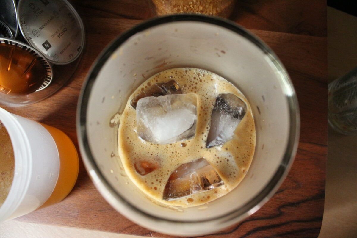 Up close photo of coffee glass filled with espresso and ice.